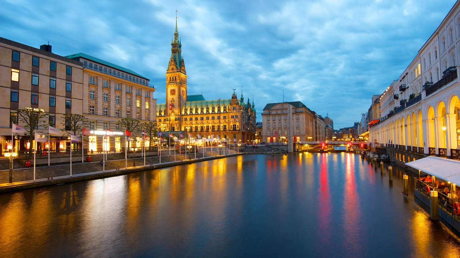 Hamburg city hall and the Alster canal at dusk